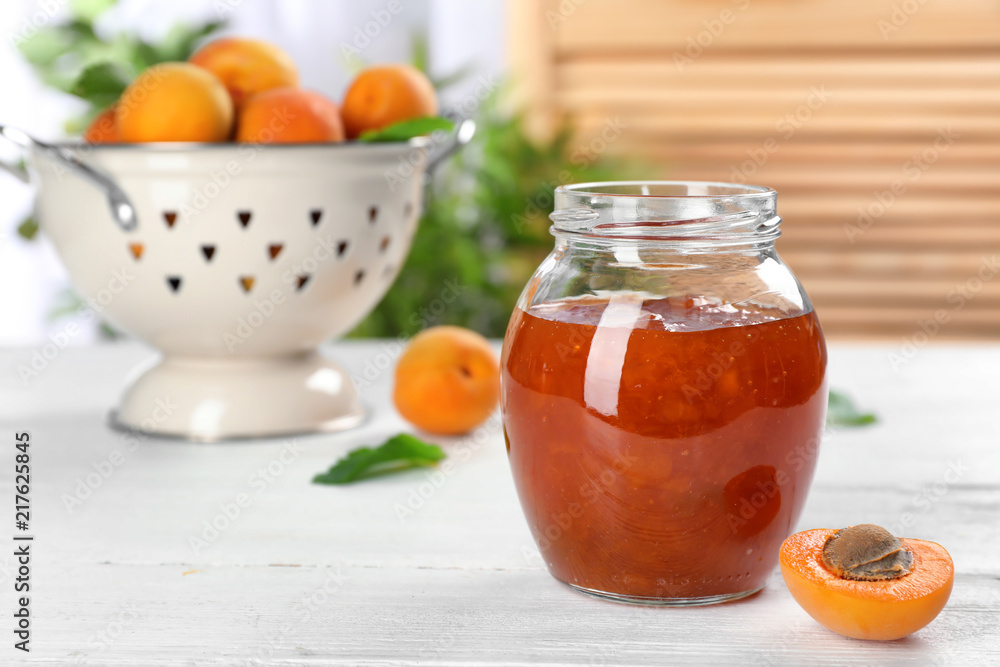 Jar with tasty apricot jam on table Jar with tasty apricot jam on table