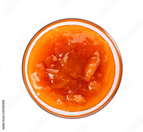 Bowl with tasty apricot jam on white background, top view