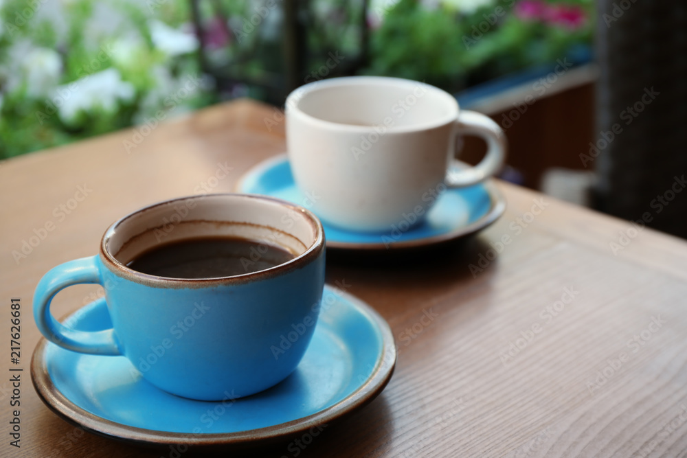 Cups of fresh aromatic coffee on wooden table Cups of fresh aromatic coffee on wooden table