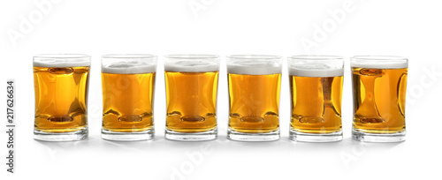 Glass mugs of beer on white background