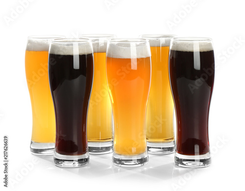 Glasses with different beer on white background