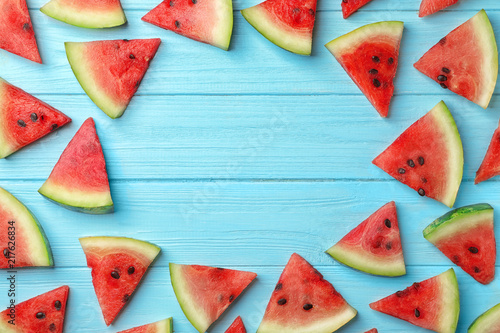 Slices of watermelon on wooden background, flat lay composition with space for text