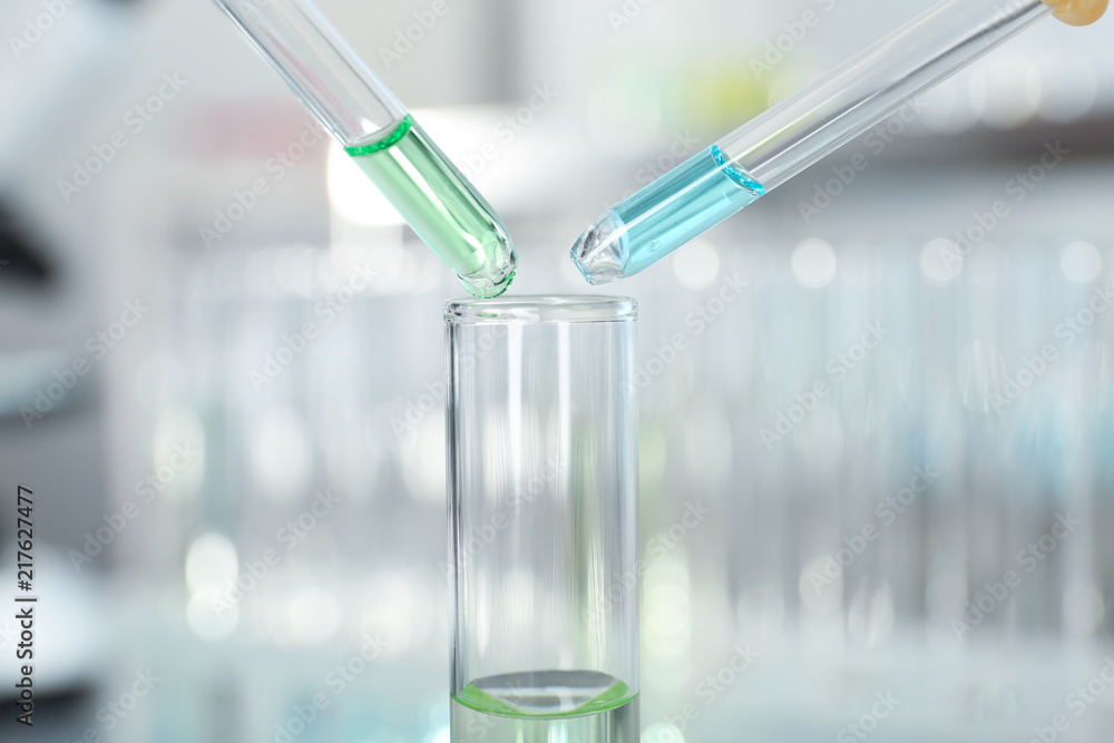 Dripping reagents into test tube with sample at laboratory. Chemical analysis Dripping reagents into test tube with sample at laboratory. Chemical analysis