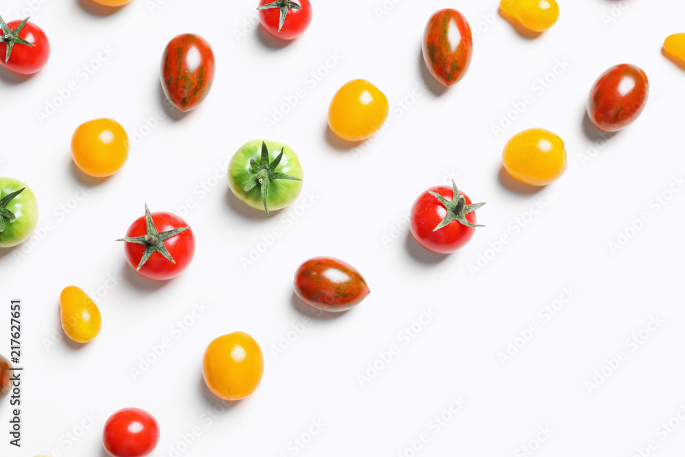 Obraz premium Flat lay composition with different tasty tomatoes on white background