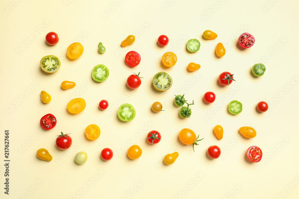 Flat lay composition with different tasty tomatoes on color background Flat lay composition with different tasty tomatoes on color background
