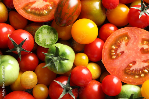 Different sorts of tomatoes as background, closeup