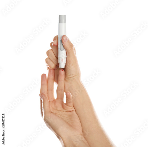 Woman using lancet pen on white background. Diabetes test
