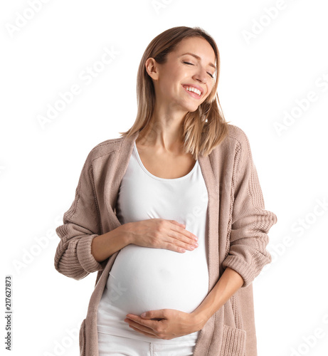 Happy pregnant woman touching her belly on white background