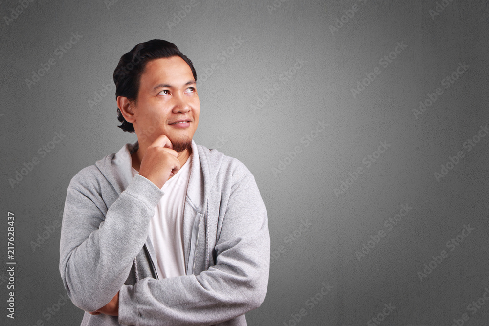 Young Man Thinking with a Smile Expression Young Man Thinking with a Smile Expression