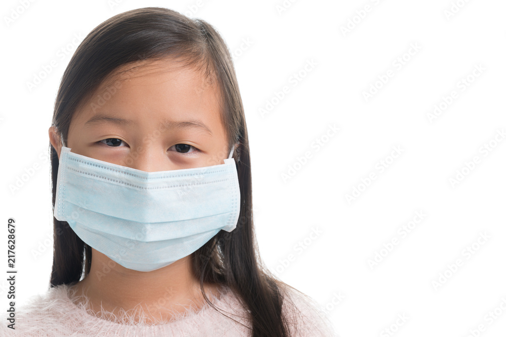 Asian kid girl age 7 years with protection mask against flu virus Asian kid girl age 7 years with protection mask against flu virus