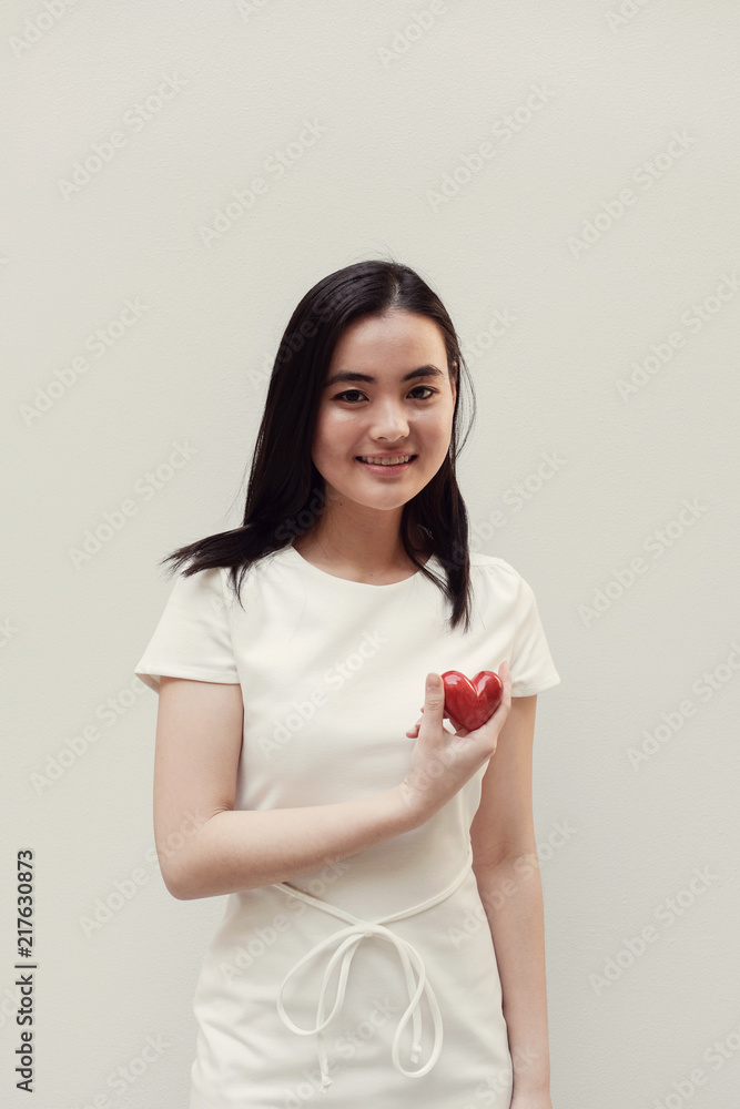 Asian young woman holding red heart, health insurance, donation concept Asian young woman holding red heart, health insurance, donation concept