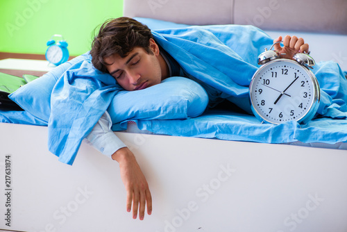 Employee in the bedroom being late for his job in time managemen photo