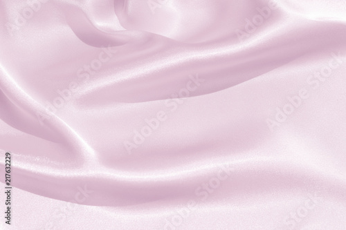 The texture of the satin fabric of pink color for the background