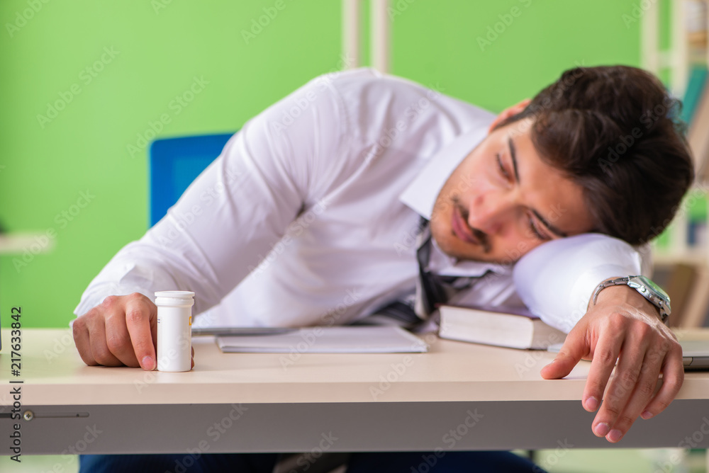 Sick and unhappy businessman sitting in the office Sick and unhappy businessman sitting in the office