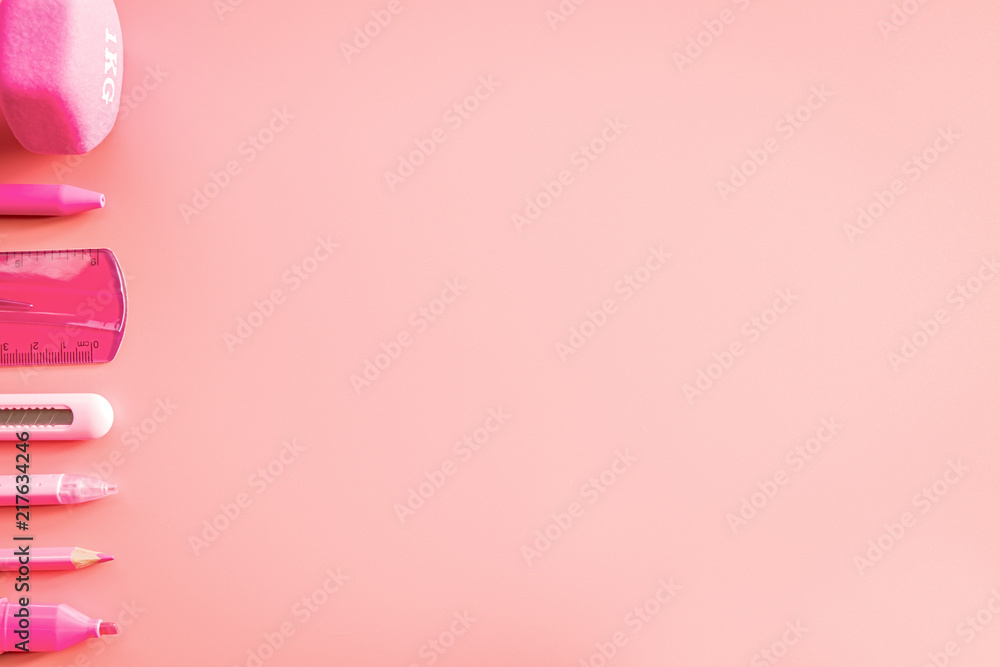 pink stationery on pink background with copy space flat lay top view