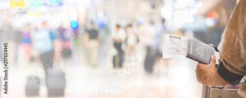 Closeup of girl holding passports and boarding pass at airport , panorama photo