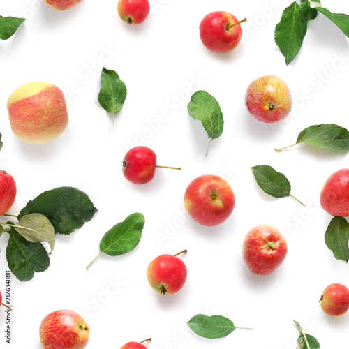 Fototapeta Naklejka Na Ścianę i Meble -  Seamless pattern of fresh red  apples with green leaves isolated on a white background, top view, flat lay. Food texture.