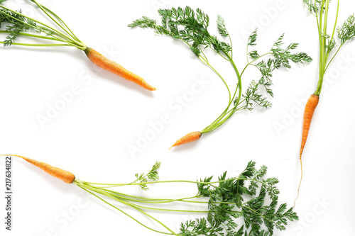 Carrots with green tops isolated on white background.