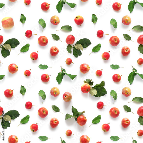 Seamless pattern of fresh red apples with green leaves isolated on a white background, top view, flat lay. Food texture.