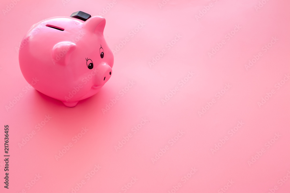 Piggy bank. Moneybox in shape of pig near hammer on pink background copy space