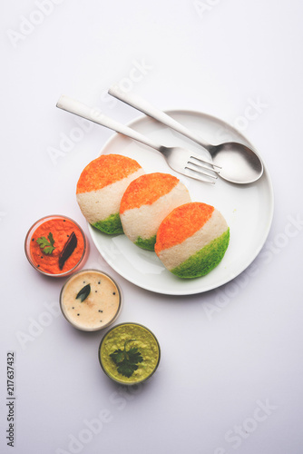 Tiranga Idly or Idli made using Indian National Flag colours like saffron, white and green. Served with colourful chutney. Concept for Happy Independence day greeting card