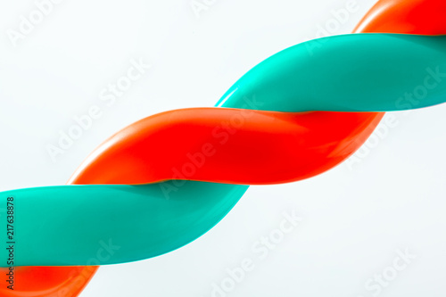 Close-up of two green and red balls bound together on white isolated background.