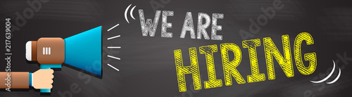Hand holding megaphone with We Are Hiring text. Hand holding megaphone with open space for your text.