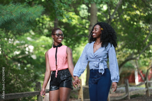 Cheerful black lesbian couple in park