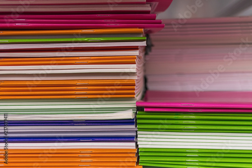 Stacks of new multi-colored terraces, soft selective focus. Office supplies for business and education.