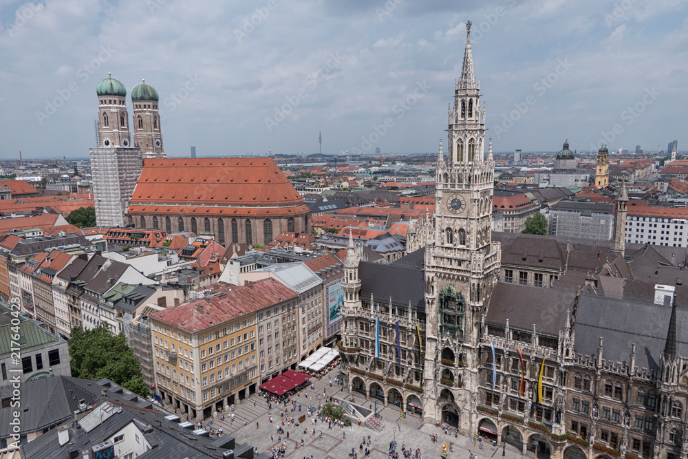 Fototapeta premium New City Hall and Frauenkirche Cathedral in the Marienplatz square of Munich, Germany are shown in a daytime, elevated view.