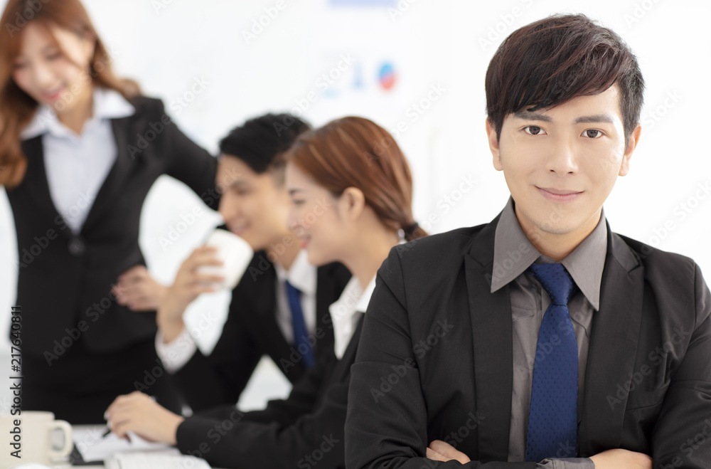 smiling business man with colleagues on background smiling business man with colleagues on background