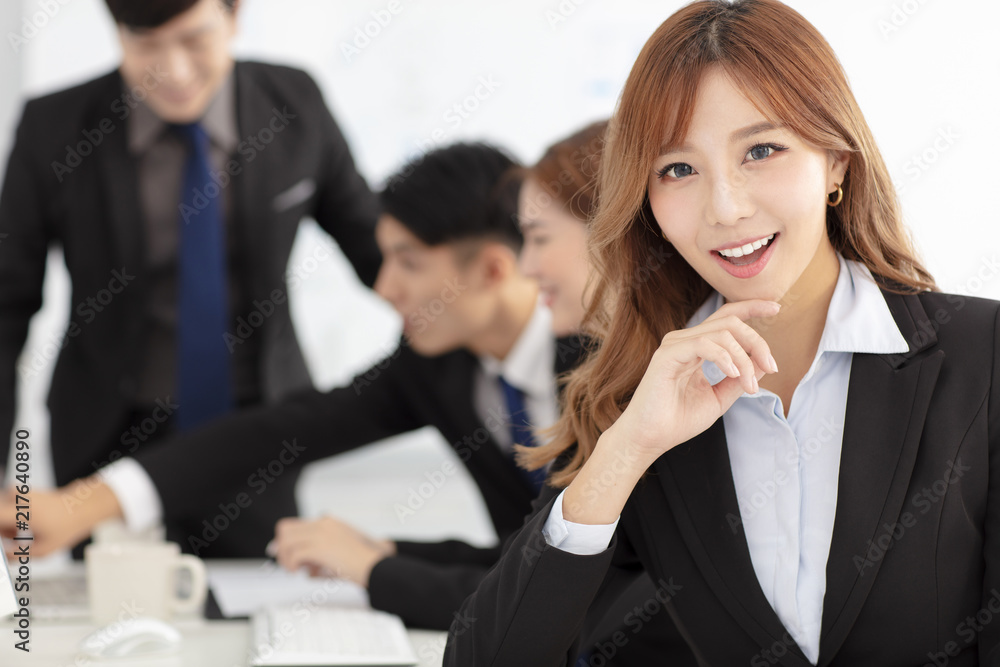 smiling business woman with colleagues on background smiling business woman with colleagues on background