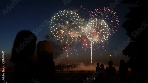 Mother and daughter watching fireworks.