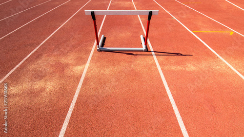 hurdle race barrier on red running track , athletic stadium