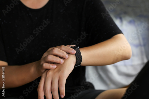 Man looking at his watch on his hand, watching the time using for concept Be Late For Something Day.
