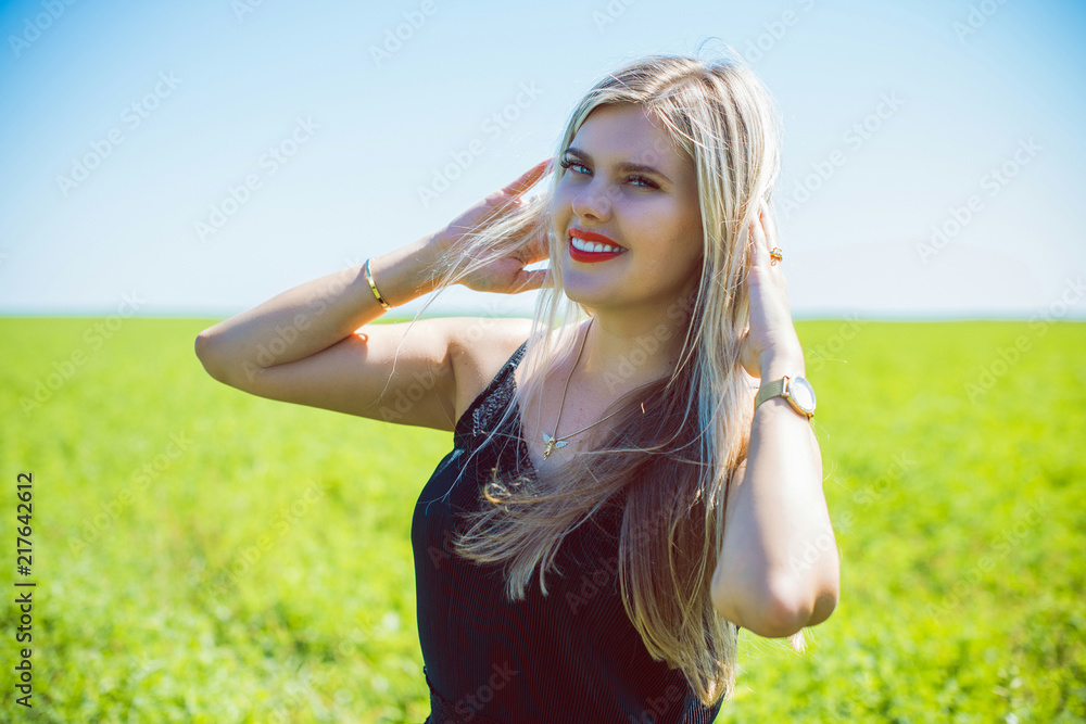Freedom concept, romantic photo of mature woman in green field, evening sun, Beauty Romantic lady in black dress Outdoors Freedom concept, romantic photo of mature woman in green field, evening sun, Beauty Romantic lady in black dress Outdoors