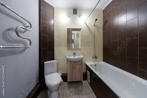 Modern brown wooden small restroom with little sink