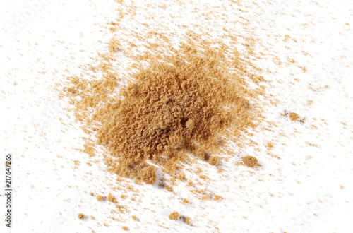 Unrefined brown cane sugar pile isolated on white background, top view