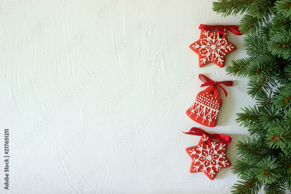 Christmas New Year holiday background, red gingerbread cookies on white table. Copy space.