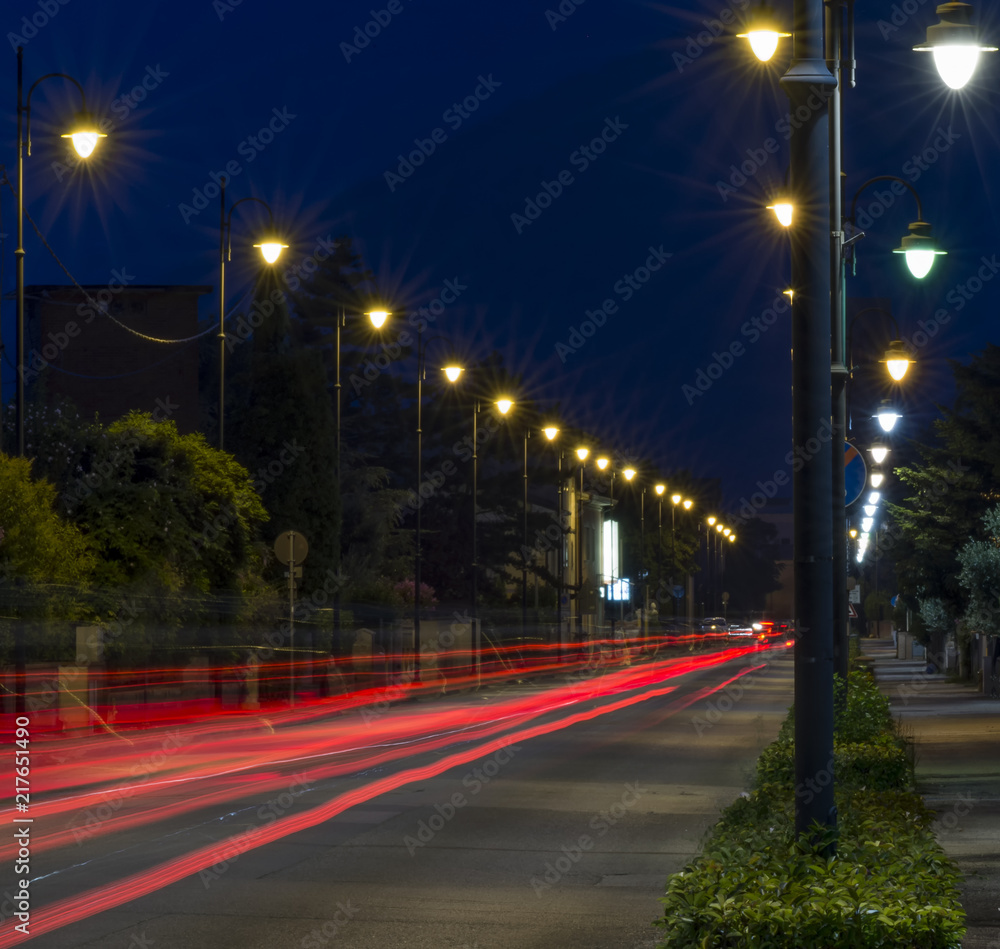Busy avenue with light trails of cars in the blue hour Busy avenue with light trails of cars in the blue hour