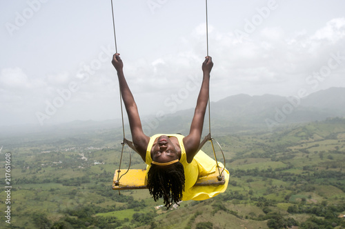 Woman swinging over the mountains