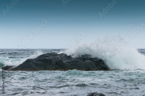 Waves are beating against rocks on the seashore, the ocean in cloudy weather. © Konstiantyn Zapylaie