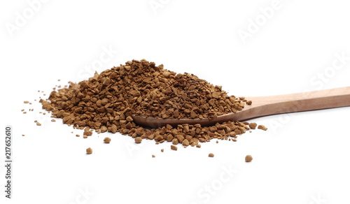 Instant coffee granules in wooden spoon isolated on white background and texture
