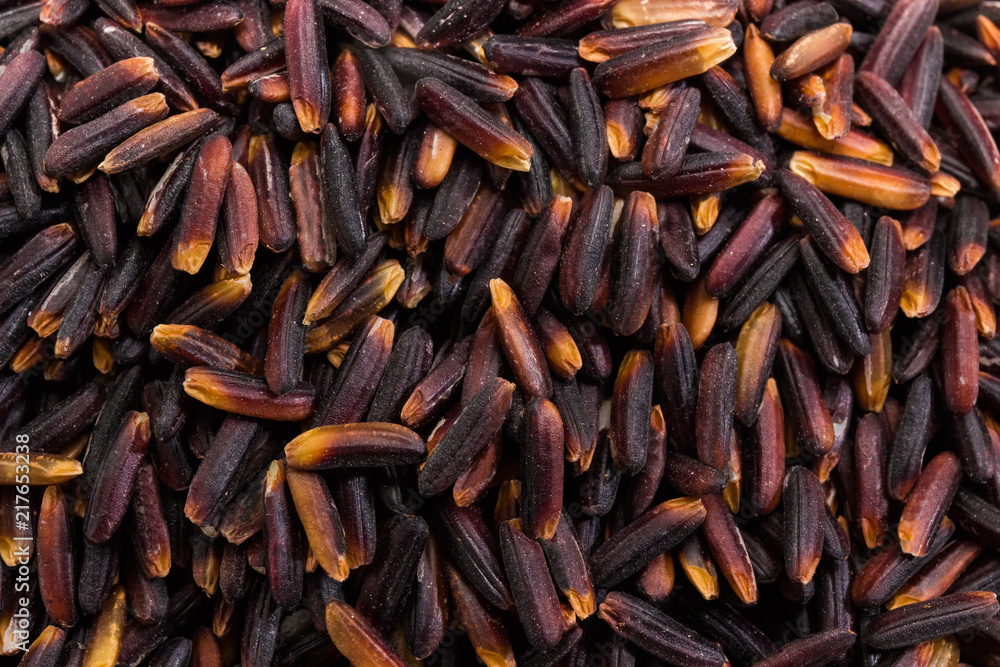 Background of the uncooked black rice close-up Background of the uncooked black rice close-up