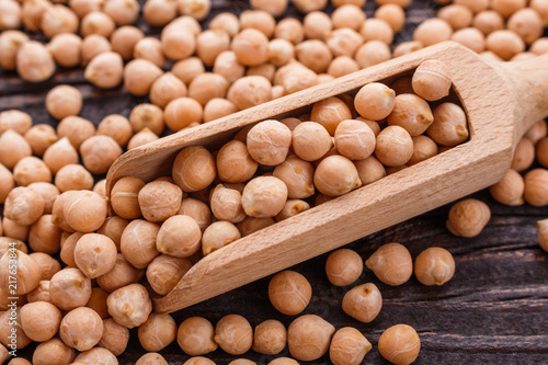 uncooked chickpeas on a wooden rustic background