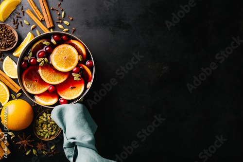 Fotografie Mulled wine with fruits in saucepan
