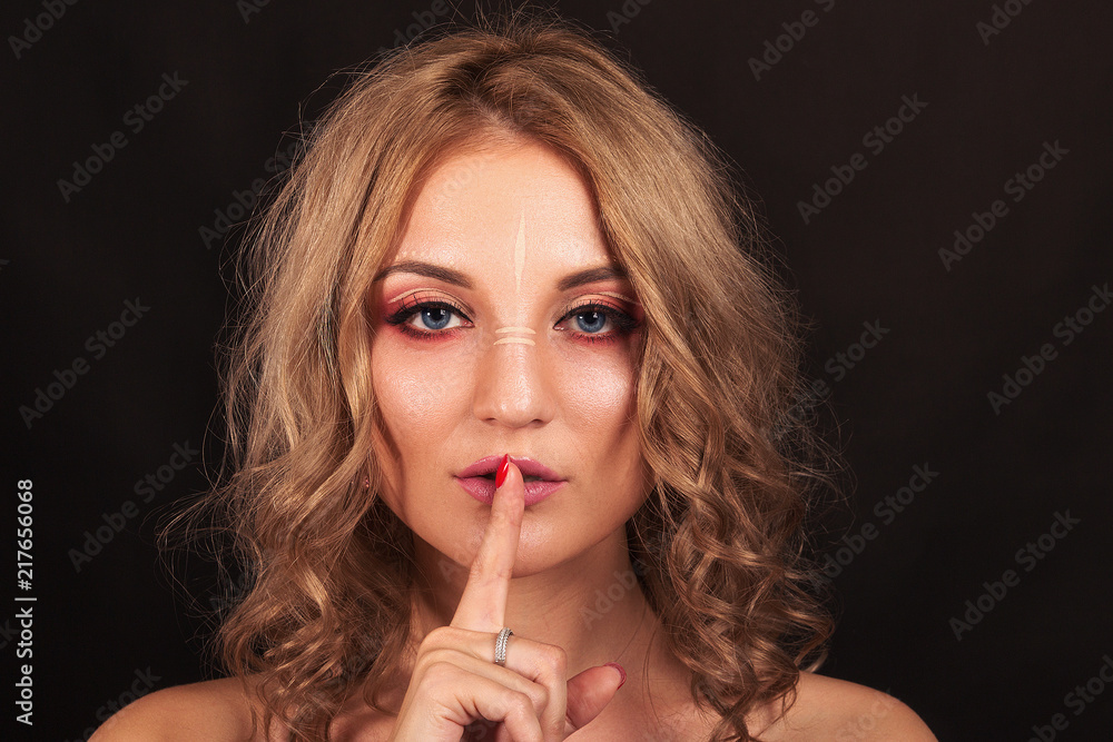 Studio portrait. Beautiful girl with evening make-up on a black background Studio portrait. Beautiful girl with evening make-up on a black background