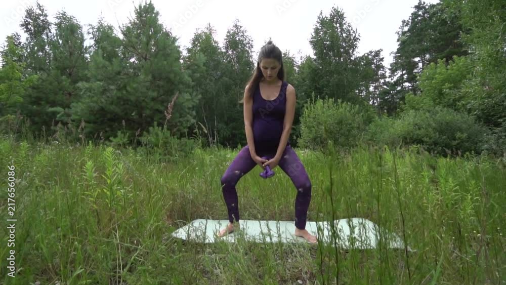 Beautiful pregnant woman doing sport in summer park. Beautiful pregnant woman doing sport in summer park.