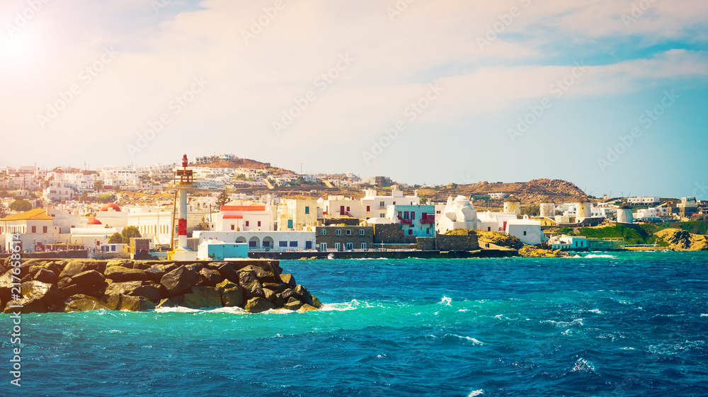 Beautiful view to Mykonos windmills and lighthouse from seaside