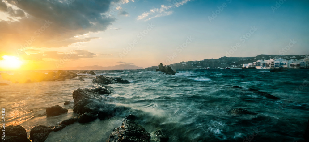 Beautiful seascape with rocks and waves at sunset